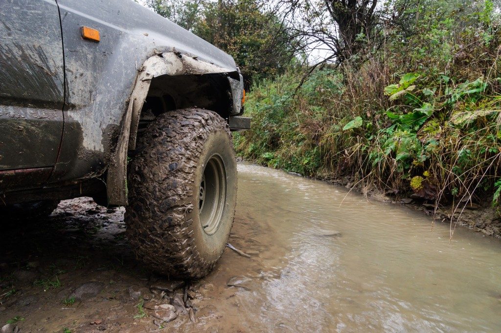A 4WD by a muddy road