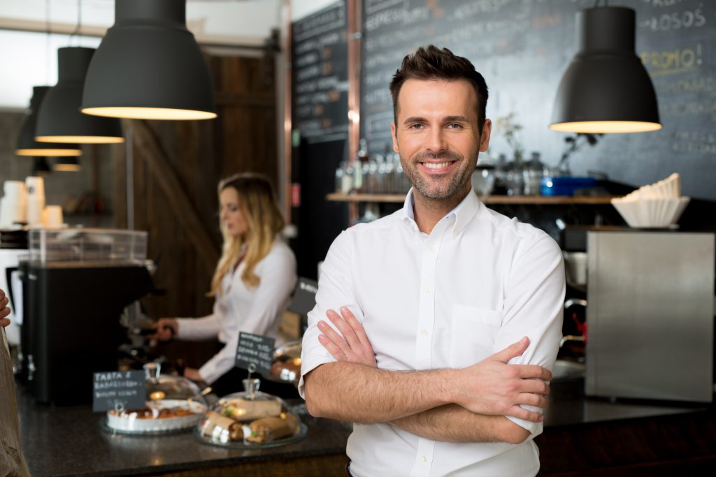Successful small business owner standing with crossed arms