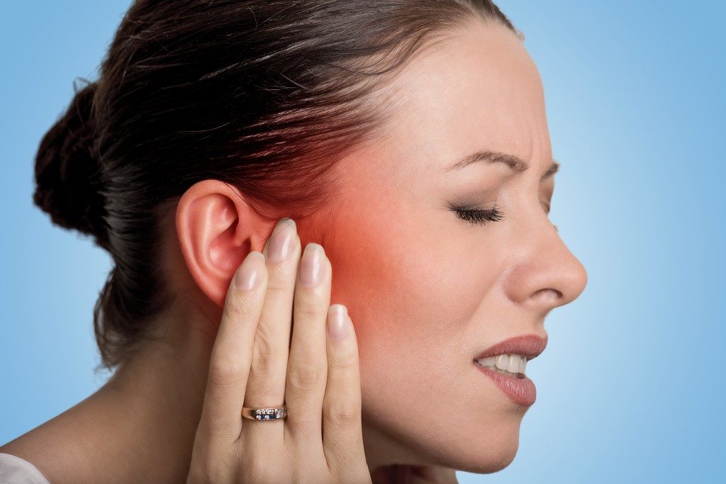 Woman having ear pain