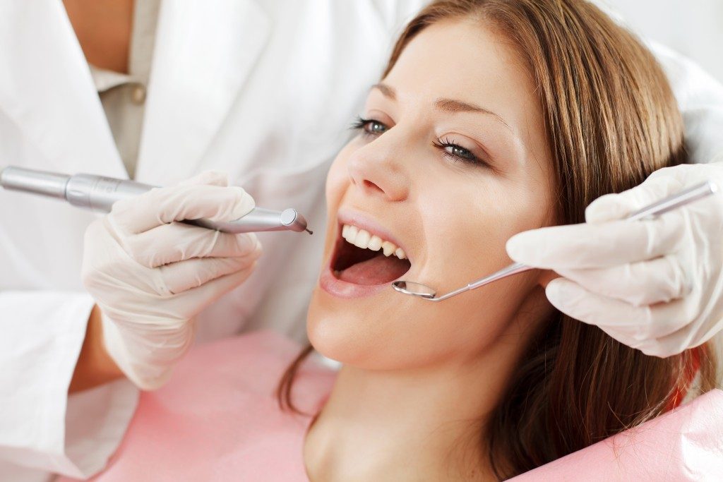 Young woman getting dental treatment