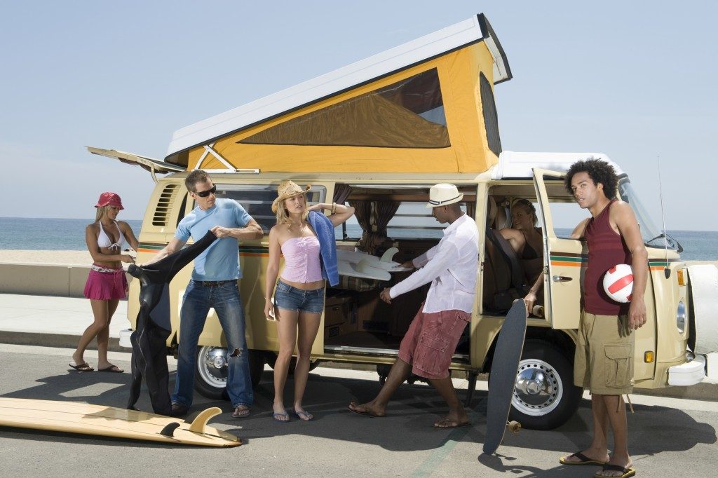 Multiethnic group of young people by campervan