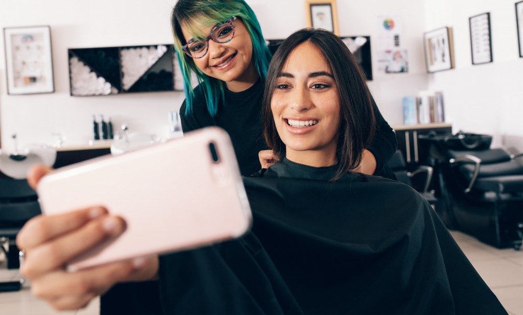 woman taking a selfie in a salon