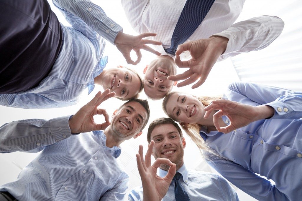 employees giving an ok sign