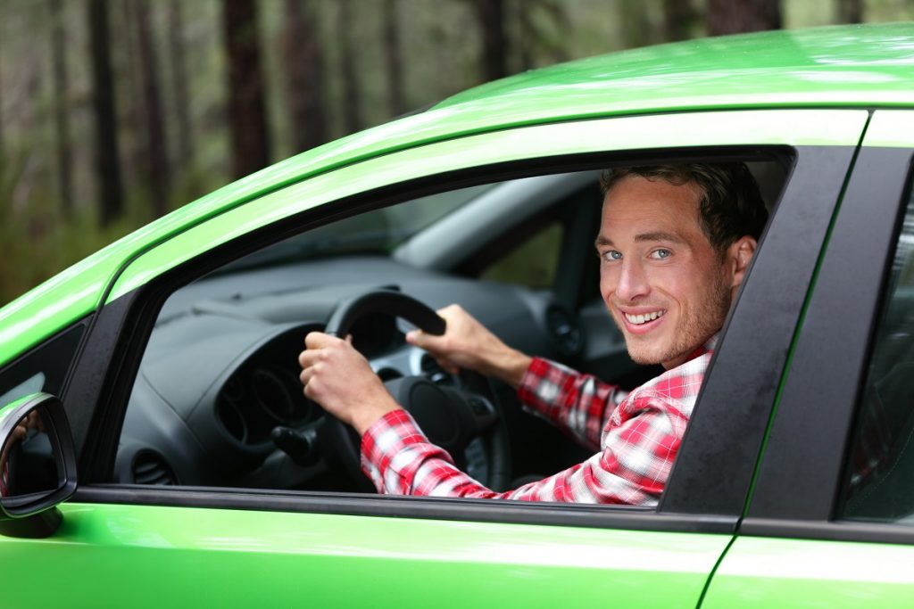 man inside green car