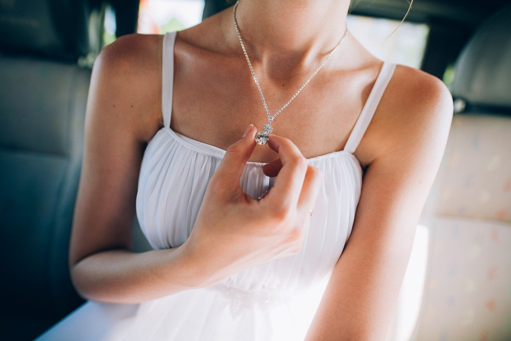 Girl in white dress wearing necklace