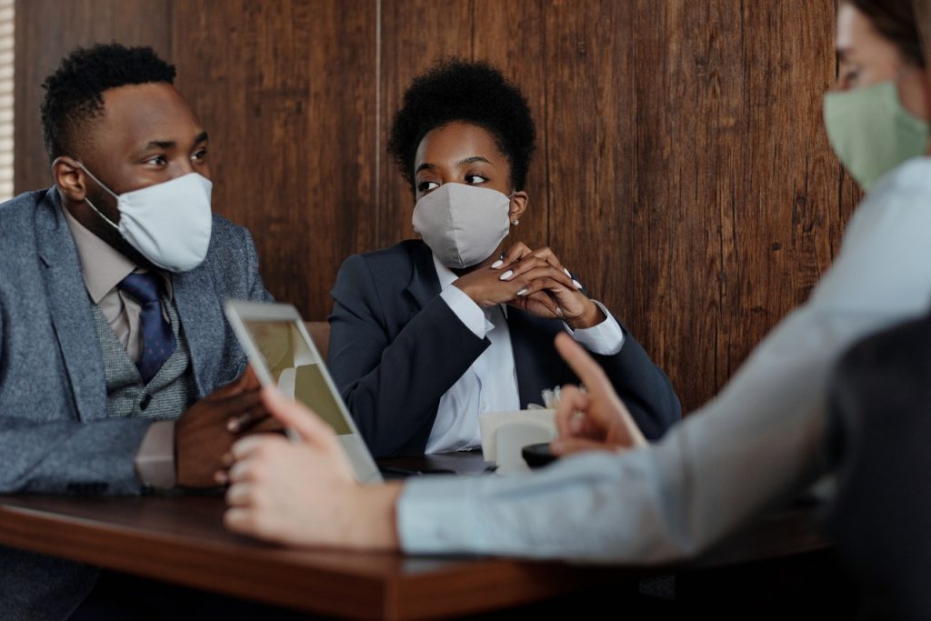 3 people having a meeting while wearing face masks