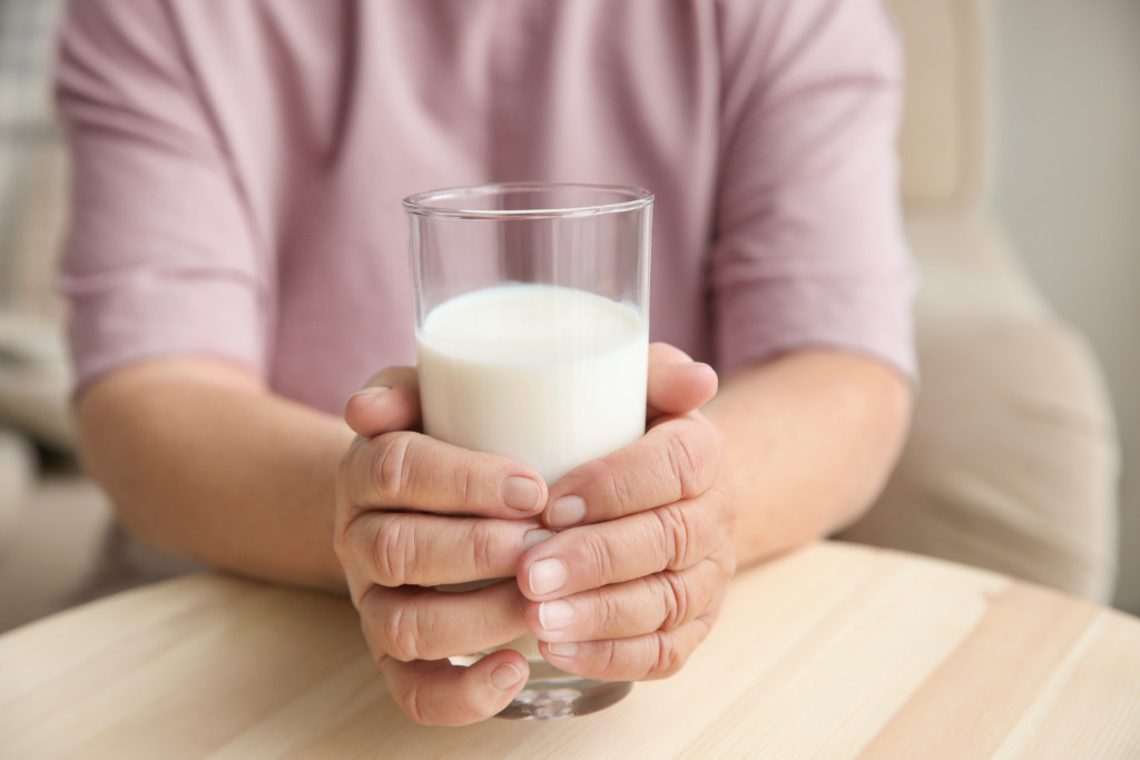 holding a glass of milk