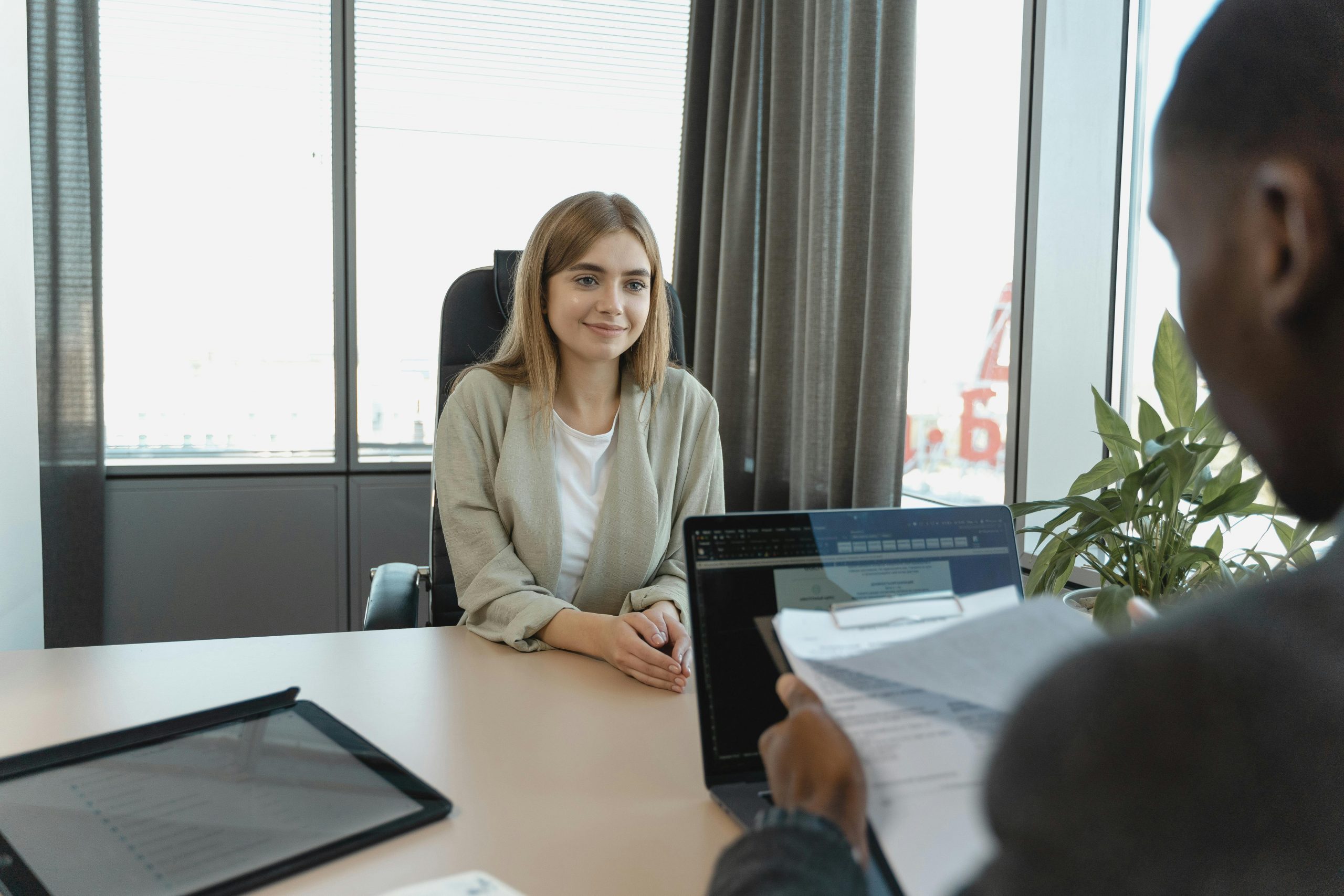 smiling woman in business attire during a job interview